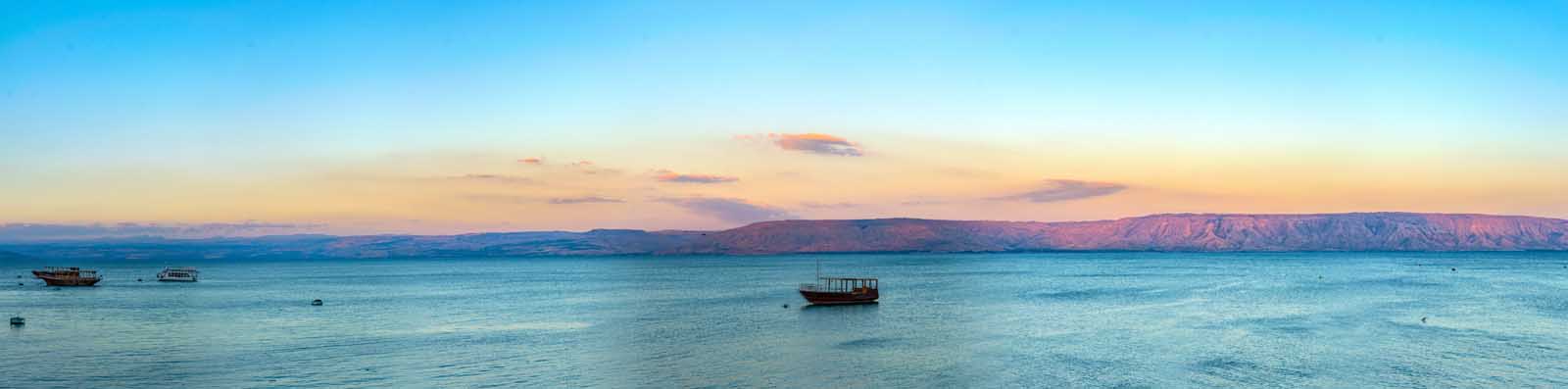 A wooden boat on the Sea of Galilee at sunset, Israel